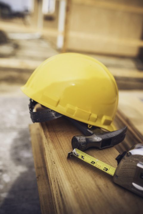 New fence construction series. Framework for picket placement. DIY. Hammer and tape measure in foreground